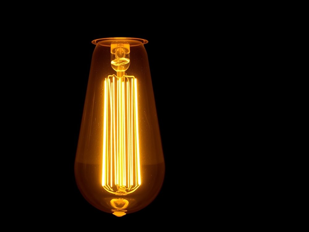 Close-up of a warm filament lamp against black